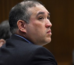 Former Michigan state Trooper Mark Bessner listens to Assistant Wayne County Prosecutor Matthew Penney deliver his opening statement in Bessner's trial, in Detroit.