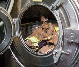 Extractors are are large washing machines that help remove carcinogens from firefighter gear. (Photo/Fire Chief)