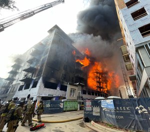 Charlotte firefighters battle a 5-alarm fire at a construction site on May 18, 2023.