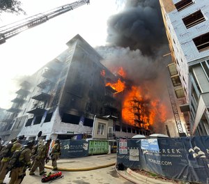 Charlotte firefighters battle a 5-alarm fire at a construction site on May 18, 2023.