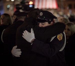 Jeremiah M. Lucey III embraces one of the Brotherton brothers after the memorial ceremony on Tuesday, Dec. 3, at the Franklin Street Fire Station.