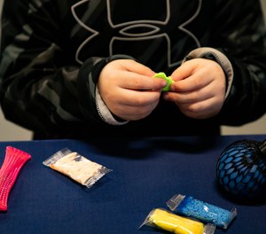 Carter Severs, 5, plays with some of the toys that can be found in the new Carter Kits, a tool to help children with autism spectrum disorder who are at the scene of an emergency, during the unveiling of the kits at Saginaw Fire Department Station #1 on Thursday, Dec. 12, 2019.