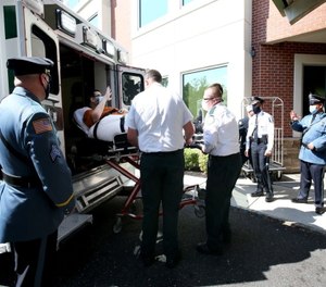 Chris Stanek waves to officers from across the state as well as rehab facility personnel as he is released from PowerBack Rehabilitation. (Photo/Lori M. Nichols for NJ.com via TNS)