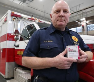 Fire District Chief Joseph Natko holds two pack of Narcan at Akron Fire station 4 on Friday Dec. 27, 2019 in Akron, Ohio.