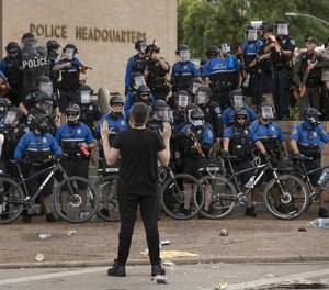 Austin police officers use bicycles to block the entrance to the Austin Police Department Headquarters during protests against racism on Saturday May 30, 2020.