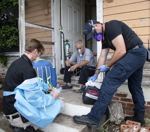 Paramedic Practitioner Travis Baker, left, and Austin-Travis County EMS Paramedic Mike Leibin check on Donna Chapman after she called 911 for breathing issues on Sept. 2. Baker treated Chapman on the spot, avoiding a trip to the hospital. (Photo/Ana Ramirez, Austin American-Statesman)