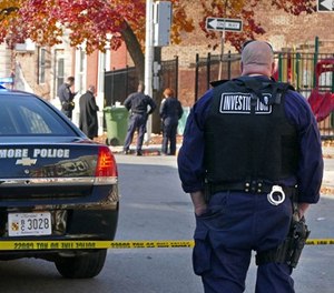 Baltimore police investigate a shooting on Nov. 30, 2017. (Lloyd Fox/Baltimore Sun/TNS)