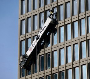 Two workers who were trapped on dangling scaffolding after the reported explosion were rescued through a window.