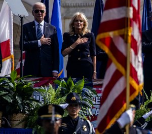 From left, President Joe Biden, first lady Jill Biden, and FBI Director Christopher Wray stand for the national anthem at the 40th Annual National Peace Officers Memorial Service on the West Front of the U.S. Capitol Building on Saturday, Oct. 16, 2021, in Washington, D.C.