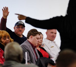 A volunteer firefighter asks a question during a town hall meeting at Buena Vista Community Center to discuss a proposed police-fire merger on Jan. 3, 2020. The town announced it is no longer considering the proposal after public backlash. (Photo/Riley Yuan, MLive.com)