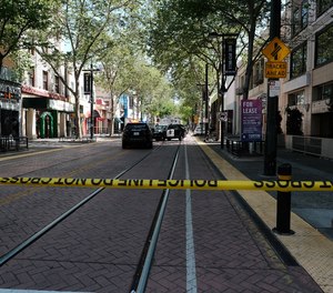 Police officers work the scene on the corner of Ninth and K streets after a shooting that occurred in the early morning hours on April 3, 2022, in Sacramento, California.