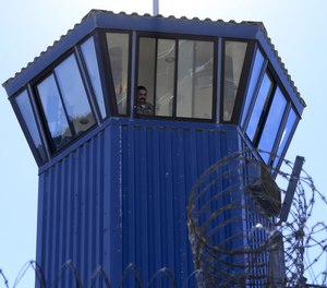 A guard watches from his tower while a group of visiting press enter a secure area on the grounds of Pelican Bay State Prison in Crescent City, California. Gov. Gavin Newsom vetoed a bill Thursday to limit solitary confinement in California's jails, prisons and private detention centers.(Mark Boster/Los Angeles Times/TNS)