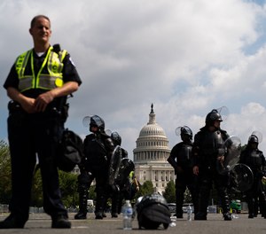 U.S. Capitol Police officers in gear stand with the dome of the Capitol in the background on Saturday, Sept. 18, 2021, in Washington, D.C.