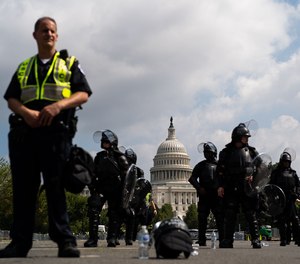 U.S. Capitol Police officers in gear stand with the dome of the Capitol in the background on Saturday, Sept. 18, 2021, in Washington, D.C.