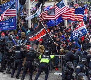 Trump supporters clash with police and security forces as they storm the U.S. Capitol in Washington, D.C, on Jan. 6, 2021.