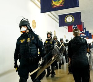 Police arrive at the Capitol to confront protesters during the joint session of the 117th Congress on Wednesday, Jan. 6, 2021, in Washington, D.C.