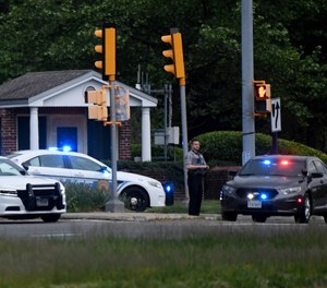 Police cars are seen outside the CIA headquarters' gate after an attempted intrusion earlier in the day in Langley, Virginia, on May 3, 2021.