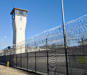 An outer perimeter fence is seen at California State Prison in Norco, Calif.