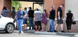 Shoppers wait in line outside the Shoot Straight gun store in Casselberry, Fla. on Sunday, March 22, 2020. The demand for firearms has skyrocketed in recent days due to the coronavirus pandemic. Image: Joe Burbank/Orlando Sentinel/TNS