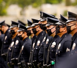 LAPD officers attend the funeral of LAPD Officer Valentin Martinez, the agency’s first sworn employee to die of complications from COVID-19, in August 2020.