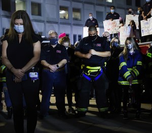 Firefighters, medical workers, first responders and members of the public gather in front of Northern Westchester Hospital to show support for the hospital and to mark the one year anniversary of the first COVID-19 patient admission to the hospital on March 11, 2021 in Mount Kisco, New York. Small bags with words of remembrance and courage lined the walkway to the employee entrance of the hospital as people cheered the medical workers during a shift change.