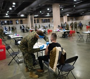 A member of the U.S. Armed Forces administers a COVID-19 vaccine at a FEMA community vaccination center on March 2, 2021, in Philadelphia, Pennsylvania.