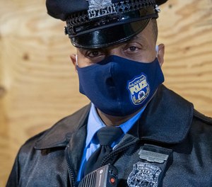 A Philadelphia police officer wears a branded face mask.