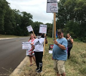 Members of the Michigan Corrections Organization picket outside the Brooks and Muskegon Correctional facilities.