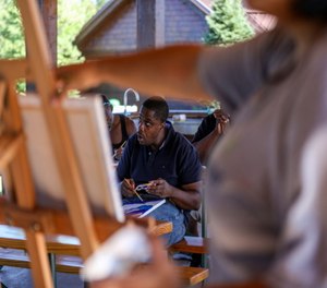 Allen Carter paints a picture during an art therapy session at the Youth Justice Fund's 2020 Trauma Summer Camp. YJF is a nonprofit that assists with re-entry for people sentenced to prison as youth.