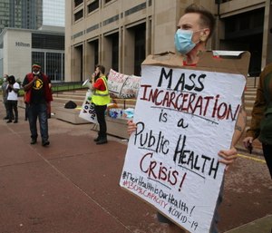Protesters gathered at the steps of the Justice Center to rally for the inhumane treatment of people incarcerated because of the spread of COVID-19. (Photo/John Kuntz of Cleveland.com via TNS)
