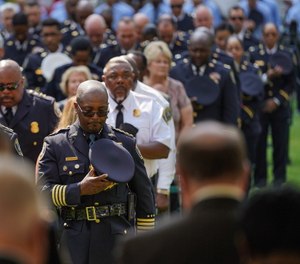 New interim Detroit Police Chief James White (center) bows his head during a 9/11 memorial service at Campus Martius Park in downtown Detroit.