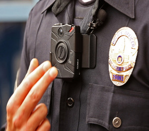 Officer Jim Stover demonstrates an LAPD body camera.