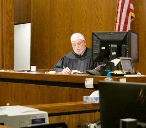 Cuyahoga County Common Pleas Court Judge Robert McClelland presides over arraignment hearings on Saturday in an effort to move people out of the Cuyahoga County Jail over concerns about the coronavirus. (Photo/Cory Shaffer via TNS)