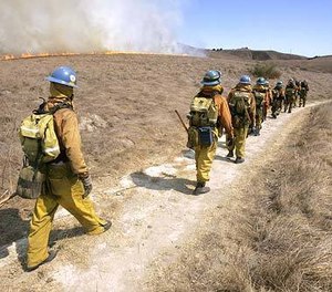 LA County firefighters move to battle a blaze near Chesebro Canyon. California payroll records reveal that firefighter overtime in the state has surged 65% over the last decade. (Photo/Ricardo DeAratanha, Los Angeles Times)