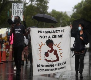 Members of Chainless Change, Black Lives Matter Alliance Broward and Broward Young Black Progressives, march in front of the Broward County Sheriff's Office in response to the recent jail house birth.