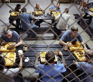 Florida inmates take a lunch break during their work shift. A recent report showed an increase in drug seizures in 2020 despite the fact visitors were not allowed the majority of the year. (Carl Juste/Miami Herald/TNS)