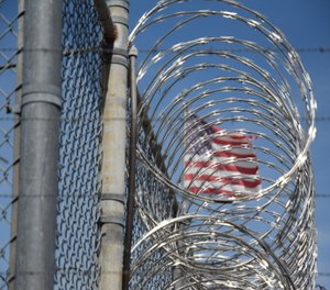 The American flag seen behind barbed wire at Holman Correctional Facility on Oct. 22, 2019.