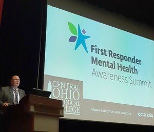 Kevin Reardon, a former firefighter with the Columbus Division of Fire and director of Central Ohio Technical College's Institute for Public Safety in Newark, welcomes about 130 attendees to the First Responder Mental Health Awareness Summit. (Photo/Holly Zachariah via Tribune News Service)