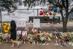 A woman walks past a memorial to those who died at the Astroworld festival outside of NRG Park on Nov. 9, 2021, in Houston.