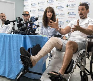 Hunter James Boyce explains how a gator that bit him had his leg in its mouth. Boyce spoke Tuesday during a press conference at St. Mary's Medical Center in West Plam Beach. His wife, Terisa Boyce, left, Danny McClellan and trauma Dr. Jorge Vega joined Boyce at the press conference.