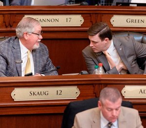Idaho state Rep. Bruce Skaug, a Nampa Republican, left, speaks with fellow Republican state Rep. Ben Adams, also of Nampa, during the 2022 House session.