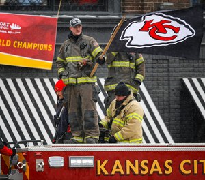 A Kansas City, Missouri, firefighter waves a Kansas City Chiefs flag atop one of the city's fire engines on Feb. 5, 2020, during a Super Bowl celebration parade.