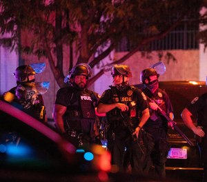 Louisville Metro Police block off Broadway after two officers were shot and a suspect was taken into custody after a march in protest of the decision concerning the officers involved in the killing of Breonna Taylor announced earlier on September 23, 2020, in Louisville, Kentucky.