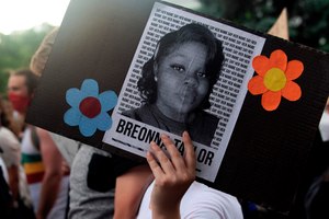 A demonstrator holds a sign with the image of Breonna Taylor, a black woman who was fatally shot by Louisville Metro Police Department officers, during a protest against police brutality, in Denver on June 3, 2020. Image: Jason Connolly/AFP/Getty Images via TNS