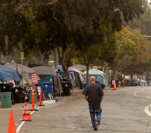 A homeless veteran walks along Veterans Row in West Los Angeles on Oct. 30, 2021.
