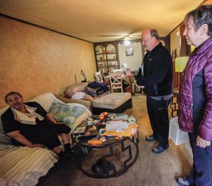 In this Nov. 28, 2019 file photo, Beverly Smith speaks with volunteers Mark and Betty Weedy as they deliver her a Thanksgiving meal. LifeCare Alliance is an Ohio program that works with fire departments and healthcare providers to reach out to those who frequently request emergency assistance. (Photo/Maddie Schroeder, The Columbus Dispatch)