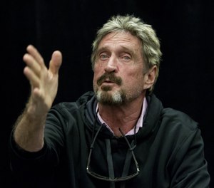 John McAfee speaks during the C2SV Technology Conference + Music Festival at the McEnery Convention Center in San Jose, Calif., in 2013.