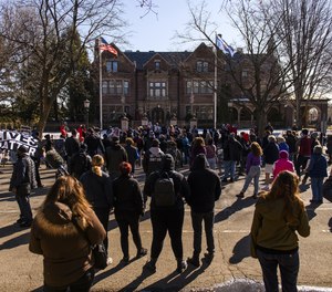 People gather for a protest demonstration outside the Governors Mansion in St. Paul, Minnesota, on Saturday, March 6, 2021.