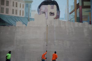 A crew from Mural Arts paints over a mural of divisive former mayor and police chief Frank Rizzo in Philadelphia. 