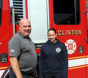 Clinton Firefighter-EMT Kacie Ortiz stands with Fire Chief Michael Lutes after starting last week as the first woman to join the department.